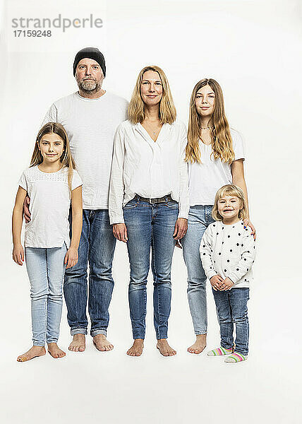 Happy family against white background in studio