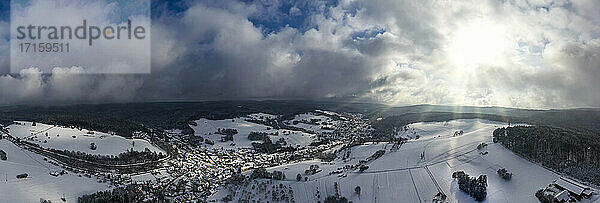 Deutschland  Bayern  Mespelbrunn  Hubschrauber-Panorama der Sonne  die den schneebedeckten Ort im Spessart beleuchtet