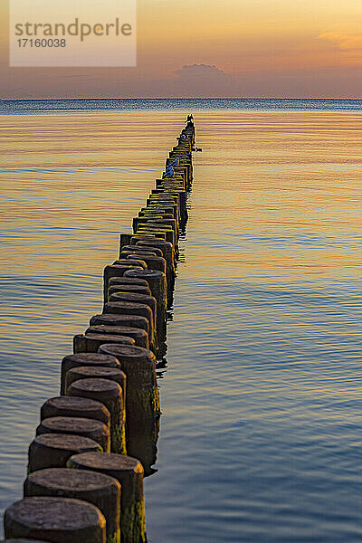 Scenic view of wooden pathway toward sea during sunset at Usedom  Mecklenburg-vorpommern  Germany