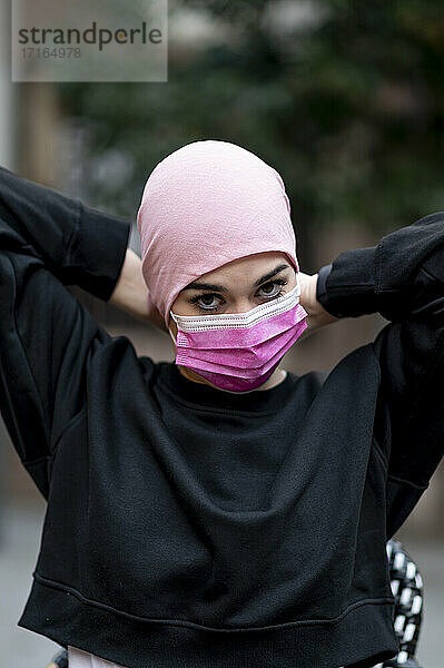 Female cancer patient wearing protective face mask during COVID-19