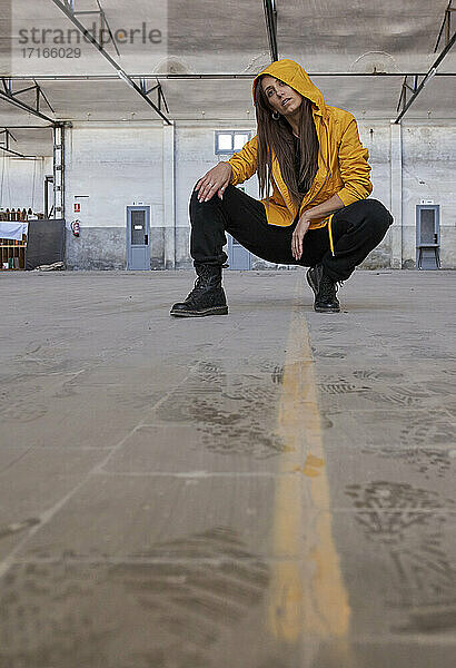 Female modern dancer practicing dance at abandoned factory