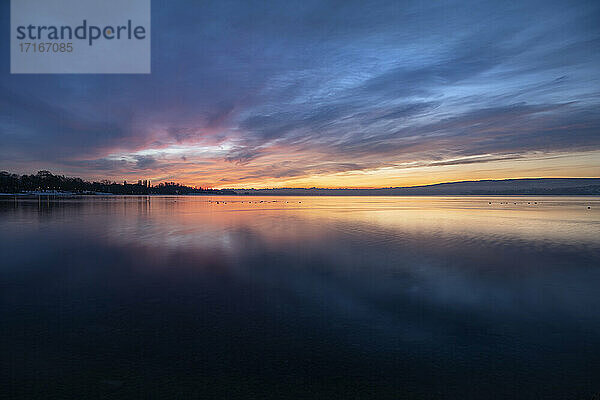 Long exposure of Lake Constance at cloudy sunrise