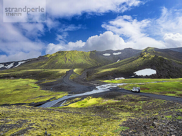 Off-road vehicle passing through Fjallabak Natural Reserve against sky  Iceland