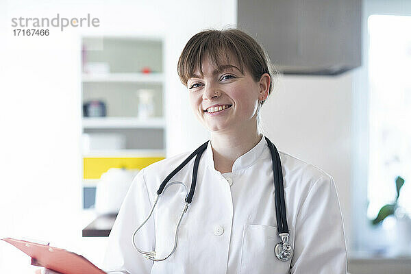 Smiling female doctor with stethoscope in hospital