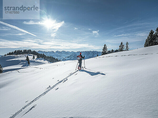 Man with ski pole exploring at Karkopf  Lattengeburge  Berchtesgadenerland; Germany