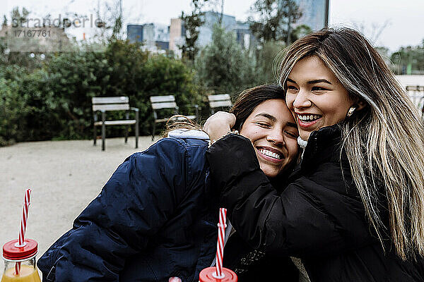 Young woman hugging her female friend