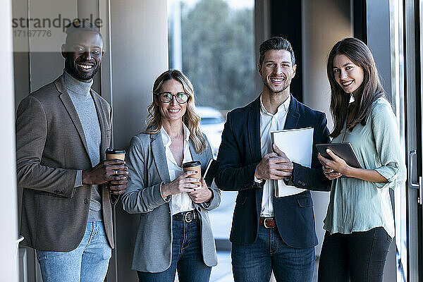 Confident business team smiling while standing together at office