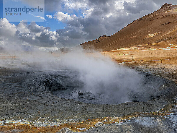 Steam emitting from geyser against mountain  Hverir  Iceland