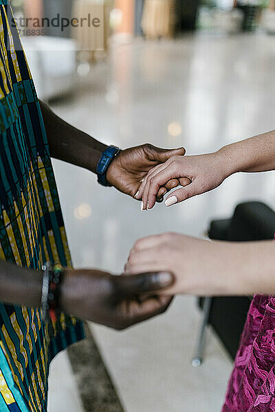 Couple holding hands while standing at banquet