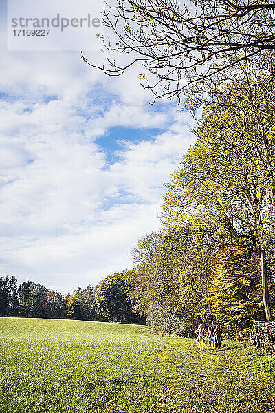 Woman walking with children at farm