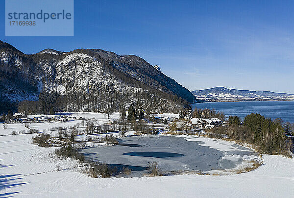 Drone view of snow-covered shore of Egelsee lake