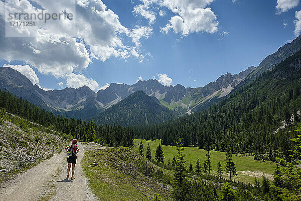 Hiker looking Karwendel mountains view while standing on footpath at Tyrol  Austria