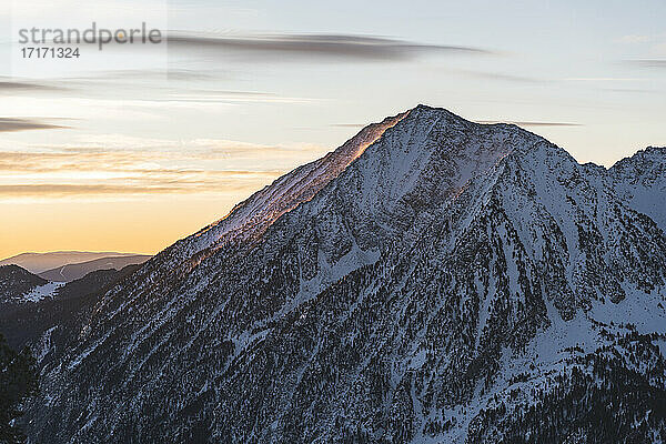 Snowcapped mountain peak during sunrise