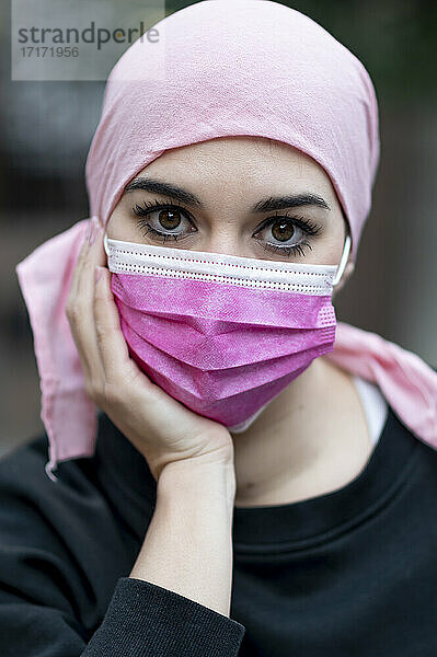 Female cancer patient with protective face mask during COVID-19