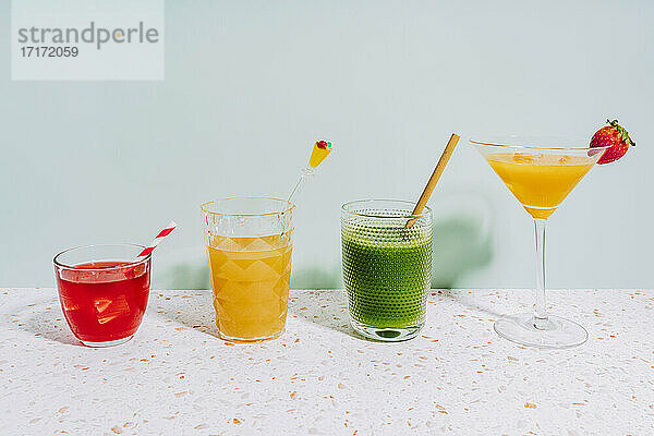 Healthy summer cocktails on terrazzo marble against wall at home