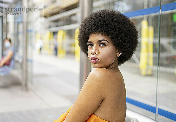 Young woman looking away at footpath