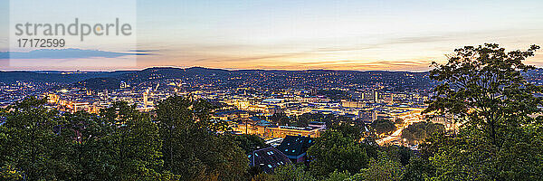 Germany  Baden-Wurttemberg  Stuttgart  Panorama of illuminated city center seen from top of Uhlandshohe hill at dusk