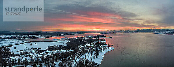 Germany  Baden-Wurttemberg  Radolfzell  Aerial view of snow-covered Mettnau peninsula at sunset
