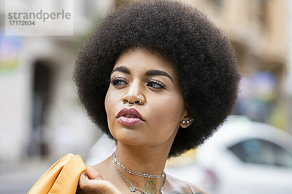 Afro woman contemplating outdoors