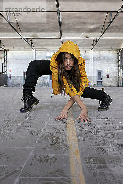 Female modern dancer dancing at abandoned factory