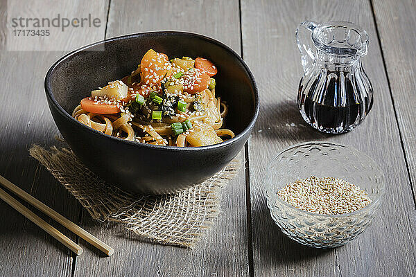 Bowl of vegan pasta with vegetables and sesame seeds