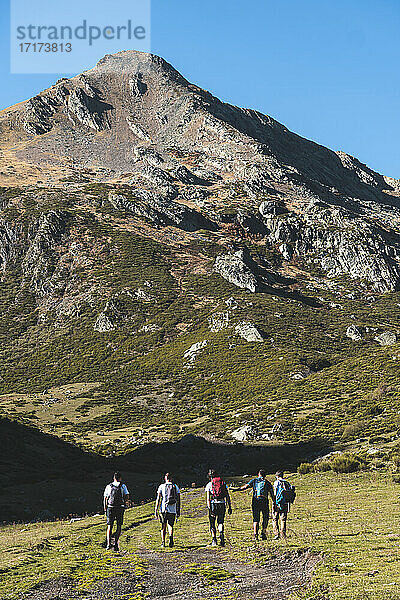 Male explorer hiking in mountain on sunny day