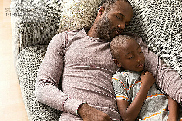 Vater und Sohn schlafen auf dem Sofa