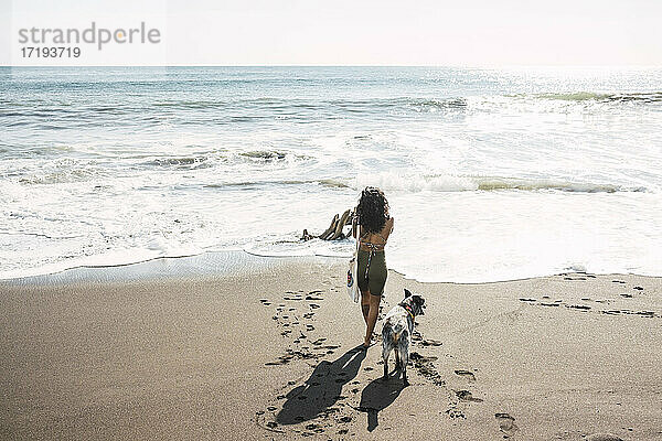 Frau fotografiert am Strand mit ihrem Hund. Konzept des Fotografen.