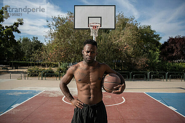 Selbstbewusster afroamerikanischer Mann macht Pause auf dem Basketballplatz