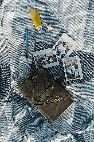 Tagebuch mit Fotos von Mann und Sahne auf Decke