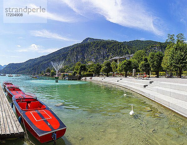 Österreich  Salzburg  Sankt Gilgen  Motorboote am Ufer des Wolfgangsees im Sommer mit Promenade und Zwolferhorn im Hintergrund