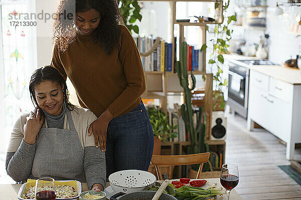 Mutter und Tochter kochen am Tisch in der Wohnung