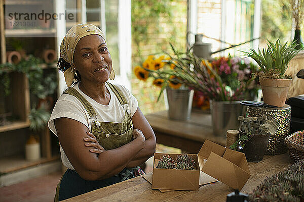Porträt zuversichtlich weiblichen Florist Boxen Sukkulenten im Laden