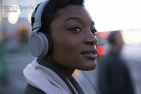Close up schöne junge Frau hört Musik mit Kopfhörern