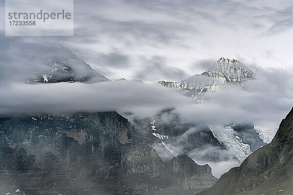 Die Berggipfel Eiger und Monch im bewölkten Himmel  Mannlichen  Grindelwald  Berner Oberland  Kanton Bern  Schweiz  Europa