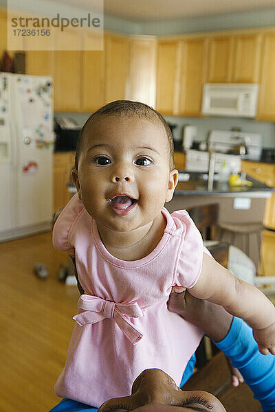 Porträt von Baby-Mädchen in der Küche Blick auf die Kamera lächelnd