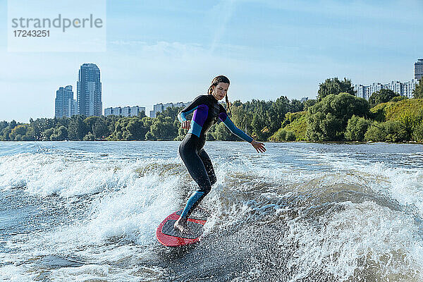 Frau beim Wakesurfen im Fluss Moskva
