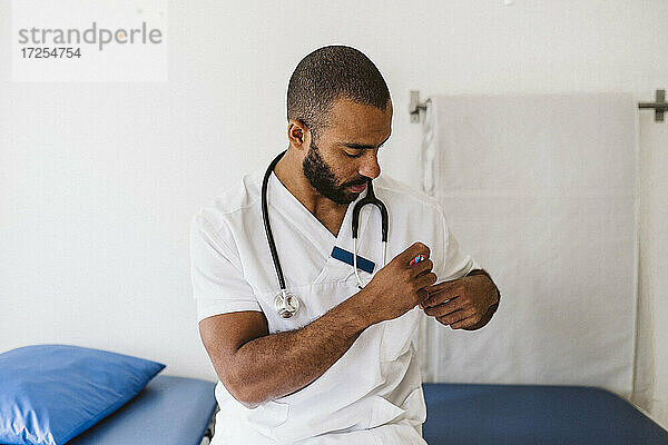 Porträt eines männlichen Arztes  der einen Stift in der Tasche hält