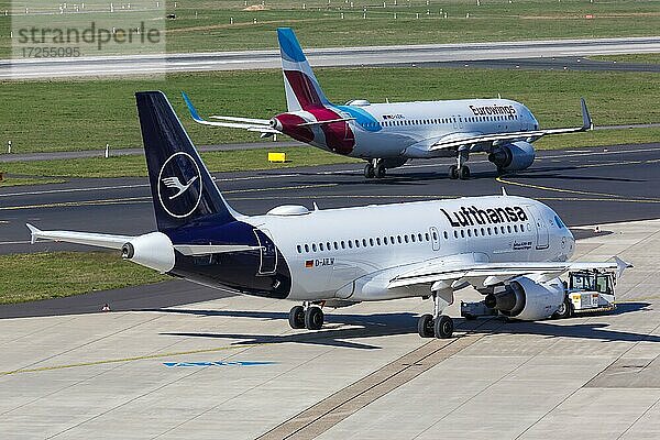 Ein Airbus A319 der Lufthansa mit dem Kennzeichen D-AILW und ein Airbus A320 der Eurowings auf dem Flughafen Düsseldorf  Deutschland  Europa