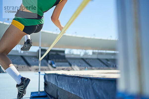 Weibliche Leichtathletin beim Hochsprung über die Stange