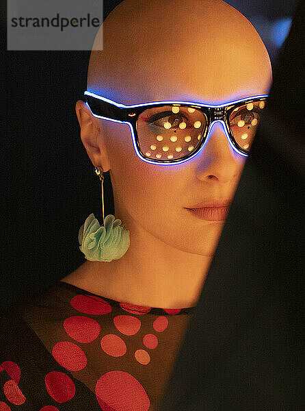 Close up Porträt stilvolle Frau mit rasiertem Kopf in Neon-Brille