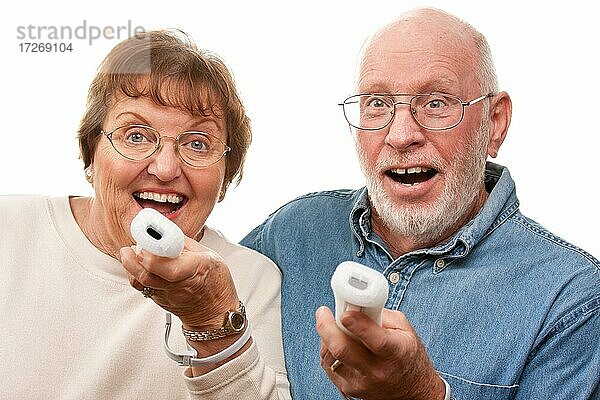 Happy Senior Paar spielen Videospiel mit Fernbedienungen auf einem weißen Hintergrund