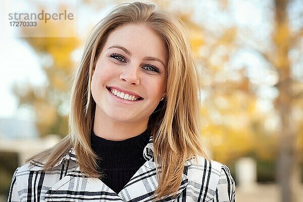 Hübsche junge Frau lächelnd im Park an einem Herbsttag