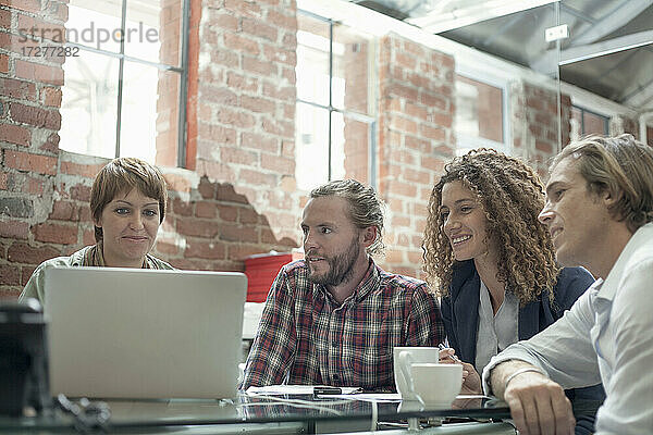 Team benutzt Laptop bei der Arbeit im Büro