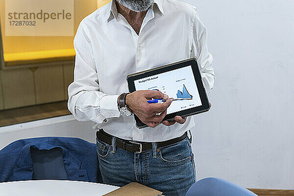 Geschäftsmann bespricht Geschäftsstrategie auf digitalem Tablet im Büro