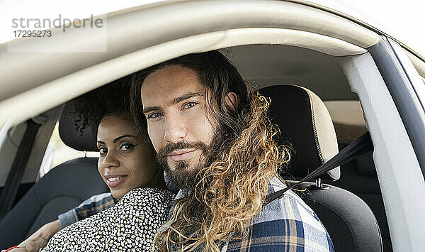Mid adult couple staring while sitting in car