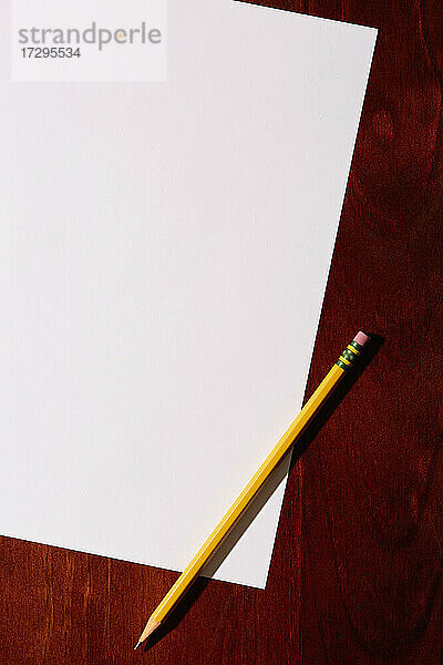 Draufsicht auf leeres Papier und Bleistift auf dem Schreibtisch