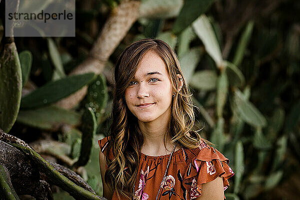 Teenager-Mädchen posiert vor einem Kaktus in San Diego