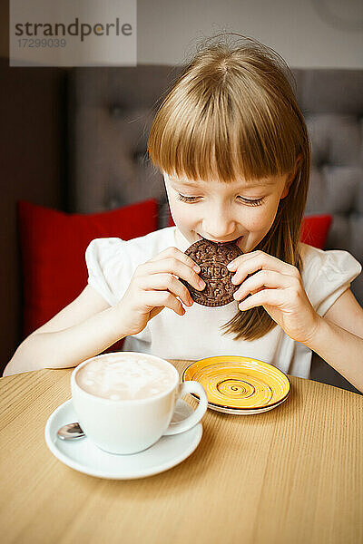 süßes Mädchen isst Schokoladenkekse