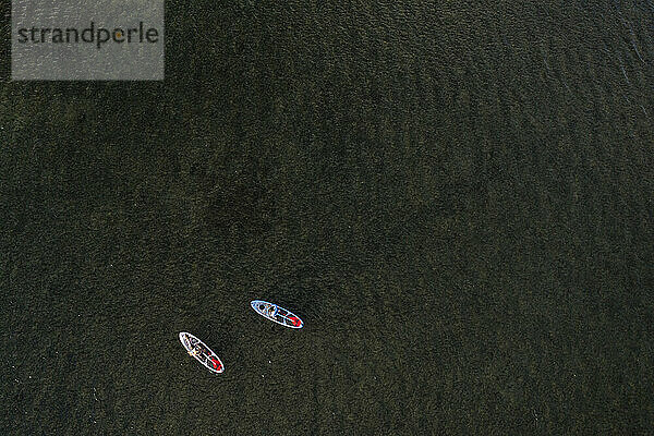 Zwei Personen auf Stand Up Paddleboards im Ozean von Hawai'i